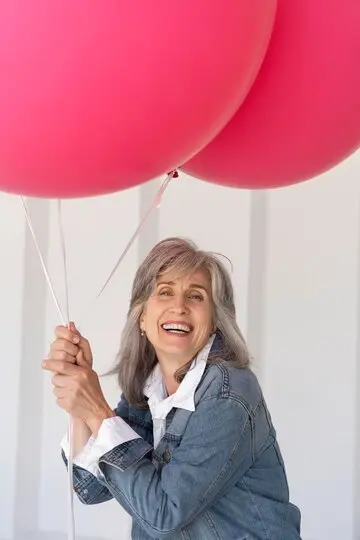 mujer jubilada globos rosa